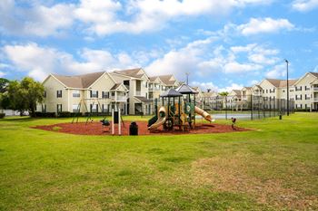 Apartment Homes Overlooking The Playground & Tennis Court Area